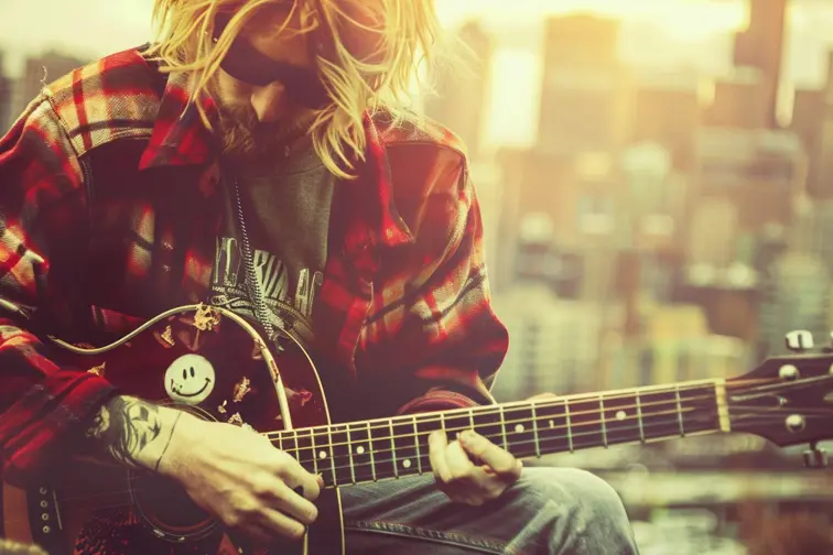 A 90's style musician poster featuring Kurt Cobain with a blurry background, incorporating grunge textures and a plaid shirt, and a distinctive logo of the band’s, retro, vintage, graphic, nostalgic, poster art.