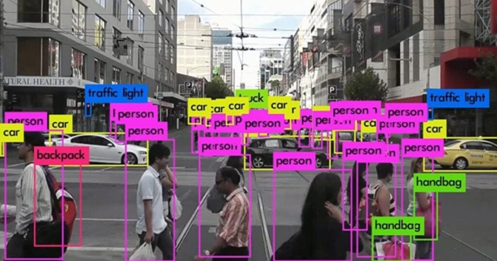 object tracking example, crowded street with tracking boxes around people, backpacks, etc